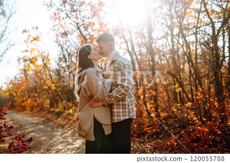 Couple in love newlyweds in casual clothes travel together, hike and walk in autumn forest in nature Couple in love newlyweds in casual clothes travel together, hike and walk in autumn forest in nature 120055788