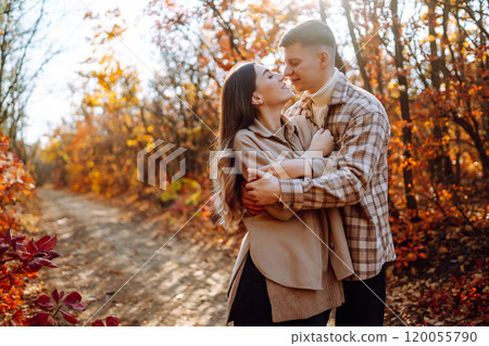 Couple in love newlyweds in casual clothes travel together, hike and walk in autumn forest in nature 120055790
