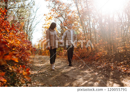 Couple in love newlyweds in casual clothes travel together, hike and walk in autumn forest in nature Couple in love newlyweds in casual clothes travel together, hike and walk in autumn forest in nature 120055791
