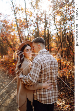 Couple in love newlyweds in casual clothes travel together, hike and walk in autumn forest in nature Couple in love newlyweds in casual clothes travel together, hike and walk in autumn forest in nature 120055796