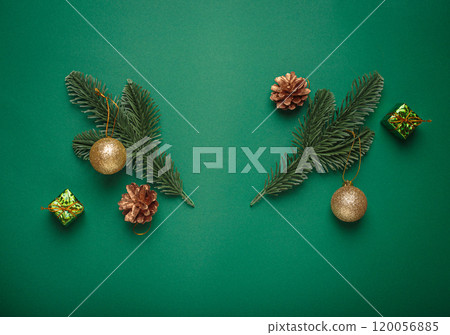 Christmas decoration on green background fir branches creating a shape of reindeer antlers framing empty space Christmas decoration on green background fir branches creating a shape of reindeer antlers framing empty space 120056885
