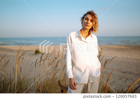 Stylish woman enjoying autumn weather outdoor. Fashion, style concept. People, lifestyle, relaxation 120057683