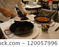 The chef serves up squid ink paella 120057996
