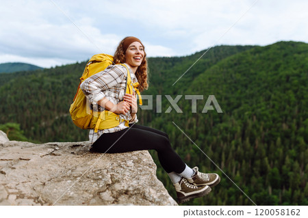 Young woman with backpack on mountain peak looking in beautiful mountain. Nature. Young woman with backpack on mountain peak looking in beautiful mountain. Nature. 120058162