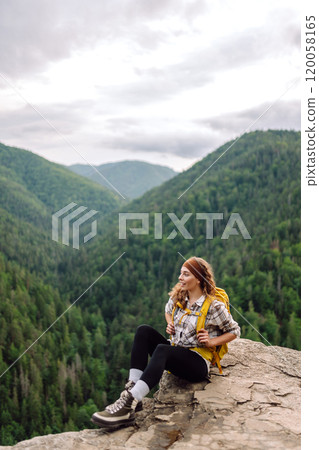 Young woman with backpack on mountain peak looking in beautiful mountain. Nature. Young woman with backpack on mountain peak looking in beautiful mountain. Nature. 120058165