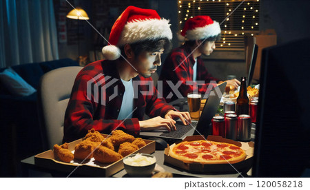 Man drinking tea on his laptop at home on Christmas Man drinking tea on his laptop at home on Christmas 120058218