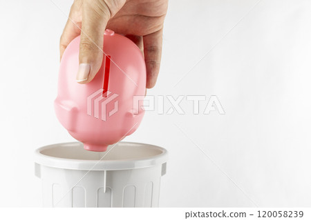 A man's hand throwing away a piggy bank (no face, 30s) 120058239