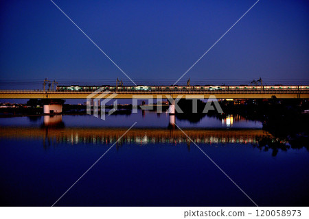 Noborito: Odakyu Line trains shining in the setting sun as seen from upstream the Tama River bank Noborito: Odakyu Line trains shining in the setting sun as seen from upstream the Tama River bank 120058973