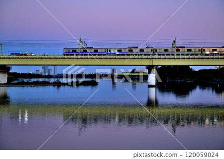 Noborito: Odakyu Line trains shining in the setting sun as seen from upstream the Tama River bank Noborito: Odakyu Line trains shining in the setting sun as seen from upstream the Tama River bank 120059024