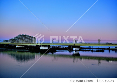 Noborito: Odakyu Line trains shining in the setting sun as seen from upstream the Tama River bank Noborito: Odakyu Line trains shining in the setting sun as seen from upstream the Tama River bank 120059025