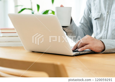 Male hand operating a personal computer Male hand operating a personal computer 120059291