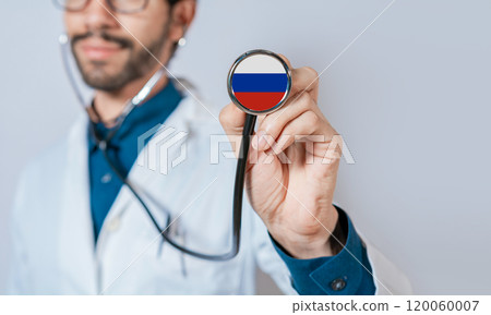 Russia flag on stethoscope. Doctor holding stethoscope with flag of Russia. Doctor showing stethoscope with flag of Russian Federation Russia flag on stethoscope. Doctor holding stethoscope with flag of Russia. Doctor showing stethoscope with flag of Russian Federation 120060007