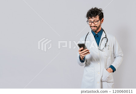 Smiling doctor using cellphone isolated. Young doctor with phone isolated, Doctor with phone on isolated background Smiling doctor using cellphone isolated. Young doctor with phone isolated, Doctor with phone on isolated background 120060011