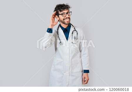 Smiling doctor listening to a rumor. Young doctor smiling with hand over ear isolated, Smiling doctor extending hand isolated Smiling doctor listening to a rumor. Young doctor smiling with hand over ear isolated, Smiling doctor extending hand isolated 120060018