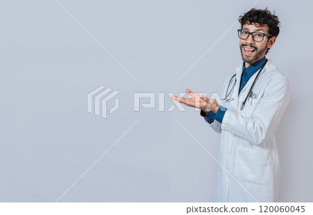 Handsome doctor showing an advertisement with his palms, Smiling doctor showing something with his palms. Young doctor presenting something with palms isolated Handsome doctor showing an advertisement with his palms, Smiling doctor showing something with his palms. Young doctor presenting something with palms isolated 120060045