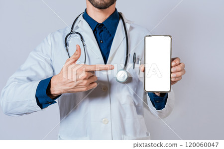 Doctor showing and pointing to blank cell phone screen. Doctor recommending on cell phone screen isolated Doctor showing and pointing to blank cell phone screen. Doctor recommending on cell phone screen isolated 120060047