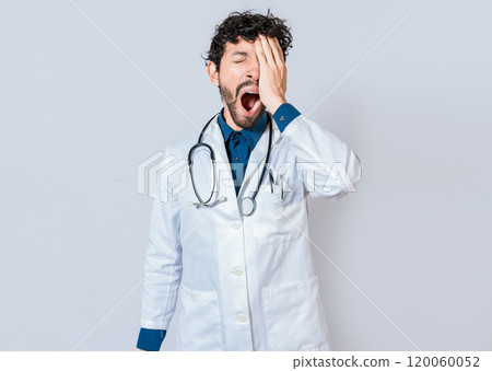 Tired and sleepy doctor isolated. Young sleepy doctor yawning on isolated background. Tired of working doctor concept Tired and sleepy doctor isolated. Young sleepy doctor yawning on isolated background. Tired of working doctor concept 120060052