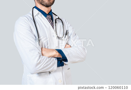Young doctor with crossed arms isolated. Unrecognizable doctor with crossed arms on isolated background Young doctor with crossed arms isolated. Unrecognizable doctor with crossed arms on isolated background 120060110