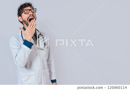 Young sleepy doctor yawning on isolated background. Tired of working doctor concept, Tired and sleepy doctor isolated Young sleepy doctor yawning on isolated background. Tired of working doctor concept, Tired and sleepy doctor isolated 120060114