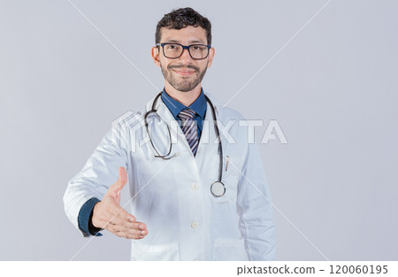 Smiling doctor shaking hands in welcome sign isolated. Friendly male doctor extending hand to camera isolated Smiling doctor shaking hands in welcome sign isolated. Friendly male doctor extending hand to camera isolated 120060195