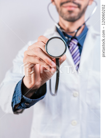 Unrecognizable doctor holding a stethoscope on white background. Close up of doctor holding stethoscope isolated 120060202