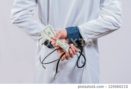 Medical corruption and bribery concept. Corrupt doctor hiding money back, Dishonest doctor hiding money Medical corruption and bribery concept. Corrupt doctor hiding money back, Dishonest doctor hiding money 120060218