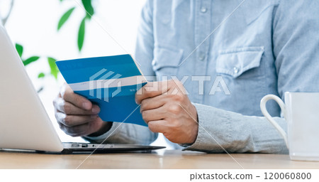 A man's hand looking at his bankbook A man's hand looking at his bankbook 120060800