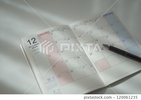 Planner opened to the December page (2024) 120061235