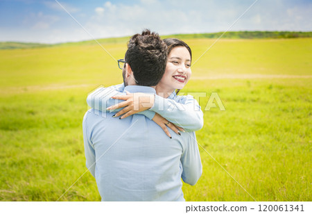 Close up of a happy couple hugging in the field, a young couple in love hugging in the green field, A man hugging his woman in a beautiful field Close up of a happy couple hugging in the field, a young couple in love hugging in the green field, A man hugging his woman in a beautiful field 120061341