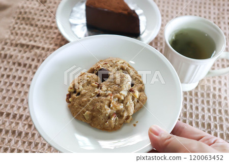 almond cookie , hot tea and chocolate cake 120063452