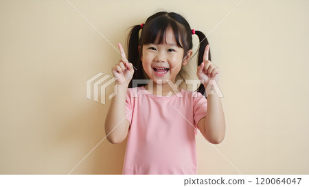 Asian Woman Happily Pointing to Upper Side with Both Fingers in Studio 120064047