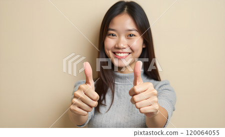 Asian Woman Happily Pointing to Upper Side with Both Fingers in Studio 120064055