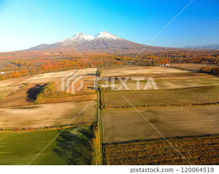 Aerial view of Mt. Komagatake covered in first snow and fallow fields in Mori Town, Hokkaido in late autumn Aerial view of Mt. Komagatake covered in first snow and fallow fields in Mori Town, Hokkaido in late autumn 120064519
