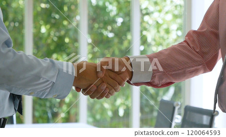 Team Business Partners shaking hands together to Greeting Start up new project. Shakehand Teamwork Partnership at office desk. Businessman partners handshake together.  Business concept 120064593