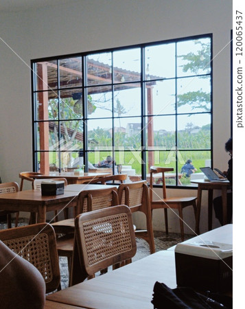Cozy Cafe Interior with Scenic Window View of Garden 120065437
