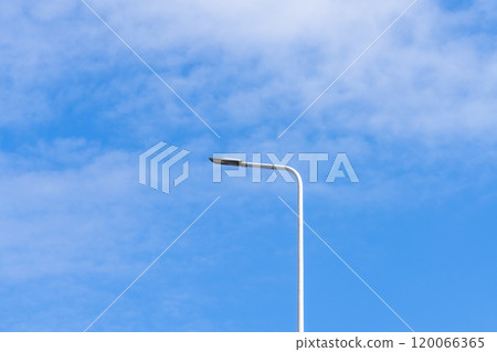 Low angle view of white street lamp under blue sky 120066365