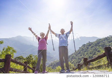 Senior cheerful couple on  mountain hike .Retired senior couple  enjoying a healthy lifestyle and freedom in nature. 120066711