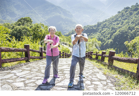 Happy asian senior couple hiking in the nature 120066712