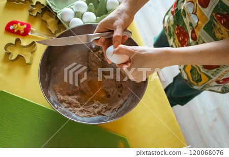 Woman in apron making ginger dough in domestic kitchen. Preparing homemade cookies. Woman hands mixing ingredients for Christmas cookies. Kneading dough proccess. Domeatic lifestyles. Real life moment Woman in apron making ginger dough in domestic kitchen. Preparing homemade cookies. Woman hands mixing ingredients for Christmas cookies. Kneading dough proccess. Domeatic lifestyles. Real life moment 120068076