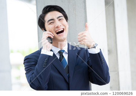 Thumbs up happy businessman 120069026