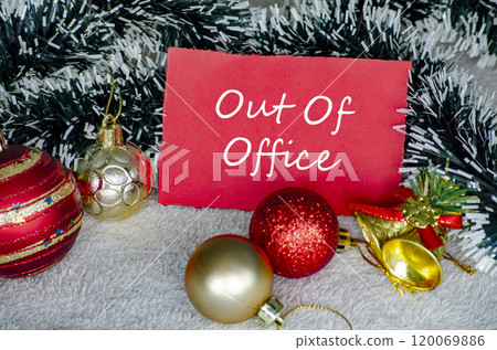 Out Of Office text on red Christmas card with Christmas decoration. Holiday season concept 120069886