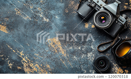 old style photo camera on abstract grey backgound, retro fashion photography concept, view from abobe, copy space 120070318
