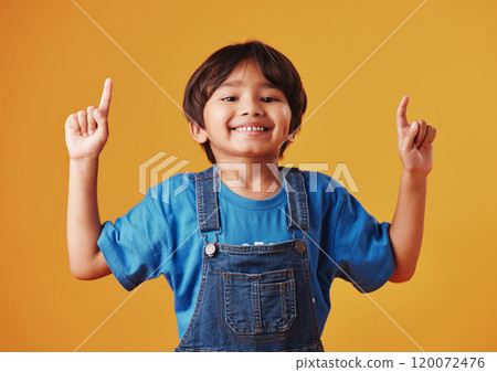 Japanese kid, boy and pointing in studio background for fashion with fun, outfit and swag in Japan. Male person, child and smile or happy on portrait in confidence with trendy clothes and style 120072476