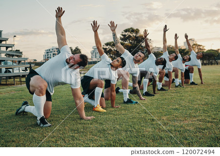 Rugby requires its players to build up the momentum. Full length shot of a group of young rugby players training on the field during the day. 120072494
