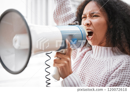 It took me a long time to develop a voice. Shot of a young woman screaming into a loud speaker while protesting in the city. 120072618