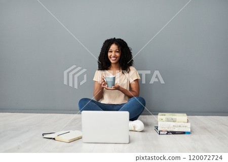You dont always need a classroom to get qualified. Studio shot of a young woman using a laptop while completing her studies against a gray background. 120072724