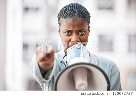 Of course I am not worried about intimidating men. Shot of a young woman screaming into a loud speaker while protesting in the city. 120072727