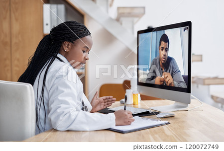 Taking notes during her virtual consult. Shot of a young doctor writing notes during a video call with a patient on a computer. Taking notes during her virtual consult. Shot of a young doctor writing notes during a video call with a patient on a computer. 120072749