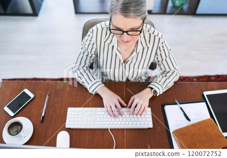 Putting her plans into action. High angle shot of a mature businesswoman working on a computer in an office. Putting her plans into action. High angle shot of a mature businesswoman working on a computer in an office. 120072752
