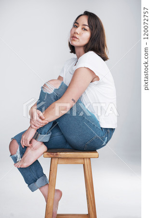 Studio, asian woman and portrait on stool for fashion, comfortable and stylish with casual clothes. Female person, model and serious on chair for trendy outfit, cool and hipster by white background Studio, asian woman and portrait on stool for fashion, comfortable and stylish with casual clothes. Female person, model and serious on chair for trendy outfit, cool and hipster by white background 120072757